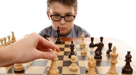 criança jogo de xadrez